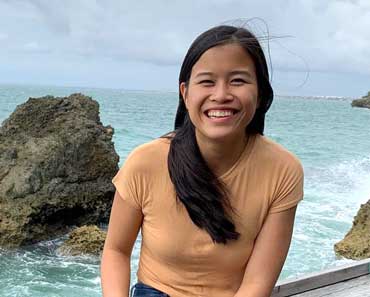 Finance fellow Melissa Kandinata pictured along a coastline